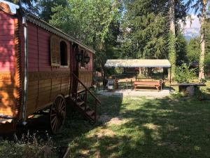 a train yard with a picnic table and a tent at La Roulotte du Fier in Annecy