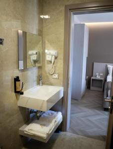 a bathroom with a sink and a mirror at Rodi Hotel Elbasan in Elbasan +30 photos