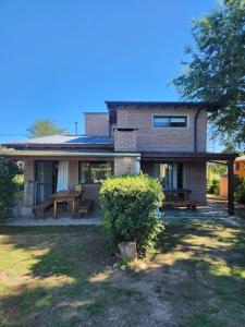 a house with a picnic table in front of it at Atardecer Serrano in Villa General Belgrano