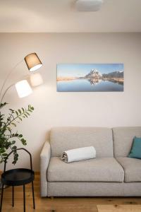 a living room with a couch and a picture on the wall at WEINBERG APARTMENTS & Brixen Südtirol Guest Pass in Natz-Schabs +93 photos