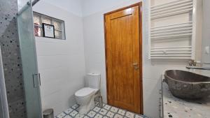 a bathroom with a toilet and a sink at Summerstone Cottage in Aliveri