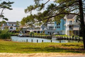 a row of houses on the water with a dock at Casa Playa in Greenbackville
