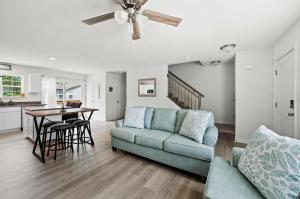 a living room with a couch and a table at Casa Playa in Greenbackville
