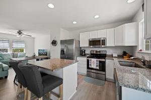 a kitchen with white cabinets and a counter top at Casa Playa in Greenbackville