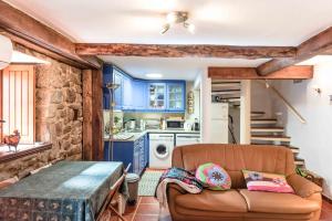 a living room with a couch and a kitchen at Cantinho de Caria in Caria