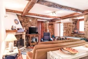 a living room with two couches and a fireplace at Cantinho de Caria in Caria