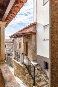 an external view of a stone building with stairs at Cantinho de Caria in Caria