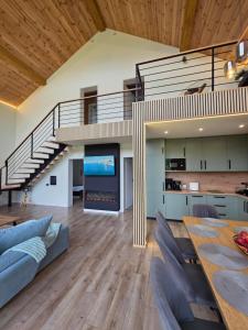an open living room with a staircase and a dining table at CabanaFriendly in Râşnov