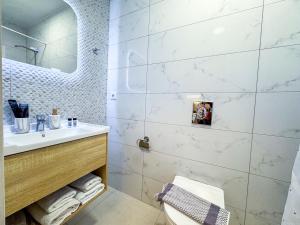 a bathroom with a sink and a toilet and a mirror at Thalassa loft in Tolo in Tolo +54 photos