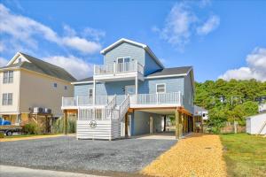 a large blue house with a balcony at Coastal Crab in Greenbackville