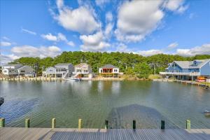 a view of a lake with houses and a dock at Coastal Crab in Greenbackville +69 photos