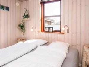 a bedroom with two white beds and a window at 4 star holiday home in Ulfborg in Ulfborg