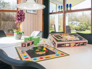 a table with two boxes on top of it at 4 star holiday home in Ulfborg in Ulfborg +37 photos