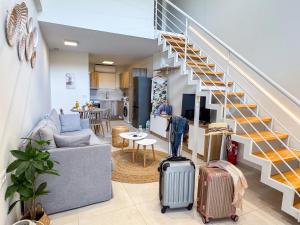 a living room with luggage and a staircase at Thalassa loft in Tolo in Tolo