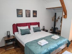 a bedroom with a bed with two towels on it at Vintage House Apart in Buzău