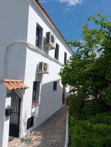 a white building with two air conditioners on it at Zahara Lovers in Zahara de la Sierra