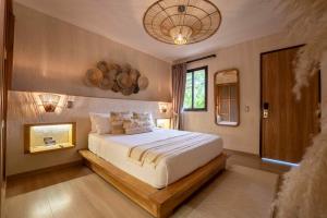 a bedroom with a large bed with a wooden frame at La Gracia Hotel & Spa in San Jerónimo +96 photos
