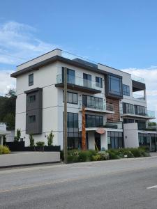 a large white building on the side of a street at PeachView Studio 103 in Peachland