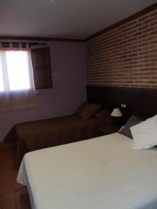 Voodi või voodid majutusasutuse Hotel Rural El Rocal toas