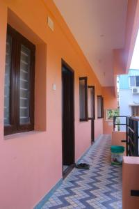 an empty hallway of a house with an open door at Yardlin Hotel in Perunkalattu