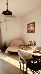 a living room with a bed and a table at Niko's apartments 1 in Elafonisos +8 photos