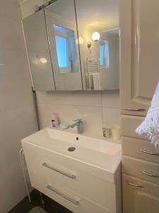 a white bathroom with a sink and a mirror at Holiday Home Ilidza Ella in Sarajevo +22 photos