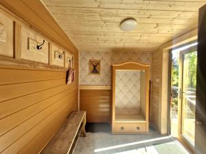 a sauna with wooden paneling and a window at Osada Bura Polana - drewniane domki z sauną in Ujsoły +187 photos