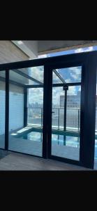 a view of a swimming pool through a glass window at Apartamento Max Derby Boulevard in Recife