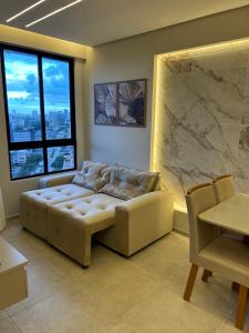 a living room with a couch and a large window at Apartamento Max Derby Boulevard in Recife +17 photos