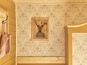 a bathroom with a picture of a deer on a wall at Osada Bura Polana - drewniane domki z sauną in Ujsoły