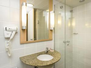 a bathroom with a sink and a shower at ibis Fortaleza Praia de Iracema in Fortaleza +121 photos
