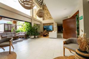 a large living room with couches and a aquarium at La Gracia Hotel & Spa in San Jerónimo