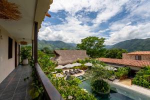 an outdoor balcony with a view of a resort at La Gracia Hotel & Spa in San Jerónimo