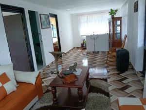 a living room with a couch and a table at villa veronica in Sasaima +16 photos