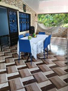 a dining room with a table and blue chairs at villa veronica in Sasaima