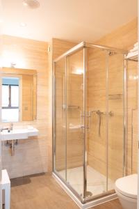 a bathroom with a shower and a sink at Hotel Olatu in Zarautz