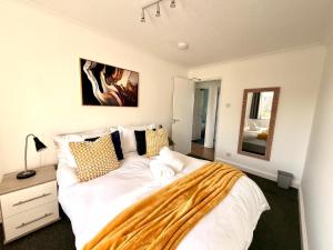 a bedroom with a large white bed and a mirror at Swan View House in Littleport +39 photos