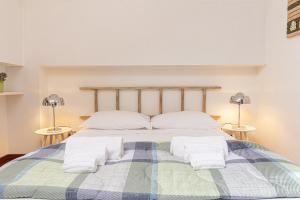 a bedroom with a bed with towels on it at Il camino felice - 201 by Houset in Monza