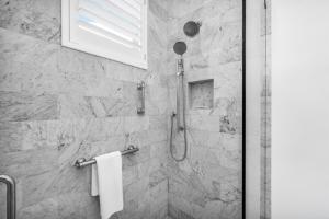 a bathroom with a shower with a glass door at The Luxe Sunshine Villa w Private Pool House in West Palm Beach