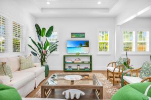 a living room with a couch and a table at The Luxe Sunshine Villa w Private Pool House in West Palm Beach
