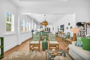 a living room with a table and chairs at The Luxe Sunshine Villa w Private Pool House in West Palm Beach