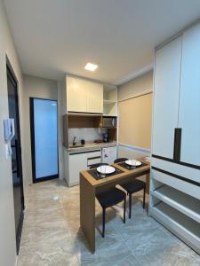 a kitchen with a table and chairs in a room at Riovale Container Lofts in Petrolina