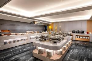 a restaurant with a table with plates on it at Changsha Rama-da by Wyndham Wuyi Square-Near Metro-Business Center in Changsha