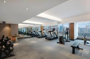 a gym with a lot of treadmills and ellipticals at Changsha Rama-da by Wyndham Wuyi Square-Near Metro-Business Center in Changsha