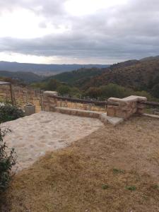 a stone bench sitting on top of a hill at Oveja Mansa in La Cumbre