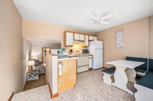a small kitchen with a table and a white refrigerator at Fishhook Hideaway in Chincoteague