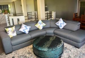 a living room with a couch with pillows on it at Tocopia and private house ddi in Sangre Grande