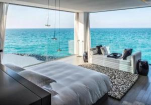 a bedroom with a view of the ocean at Tocopia and private house ddi in Sangre Grande