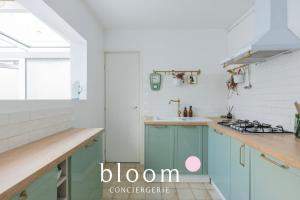 a kitchen with blue cabinets and a sink at La maison de C Moench in Nancy +21 photos