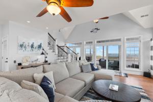 a living room with a couch and a ceiling fan at Gallops Point in Greenbackville